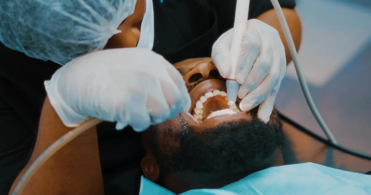 Close-up of a dentist performing a dental procedure on a patient in Lagos clinic.