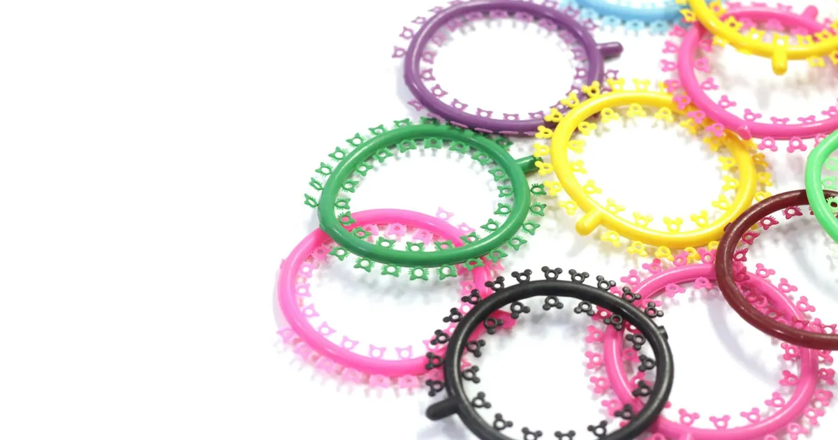 A vibrant mix of orthodontic braces bands in various colors on a white background.