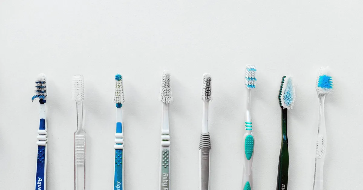 Diverse selection of toothbrushes lined up for dental hygiene focus with copy space.